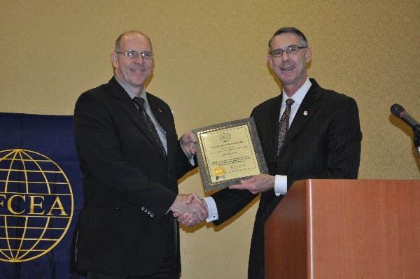Marc Purcell (r), chapter president, presents Curt Piontkowski with a Life Member certificate and pin during the chapter's monthly luncheon in September.